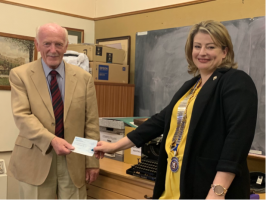 Richmond Rotary President Emma Fulton presenting a cheque for £1,000 to Gordon Alexander, one of the Directors of The Richmondshire Museum
